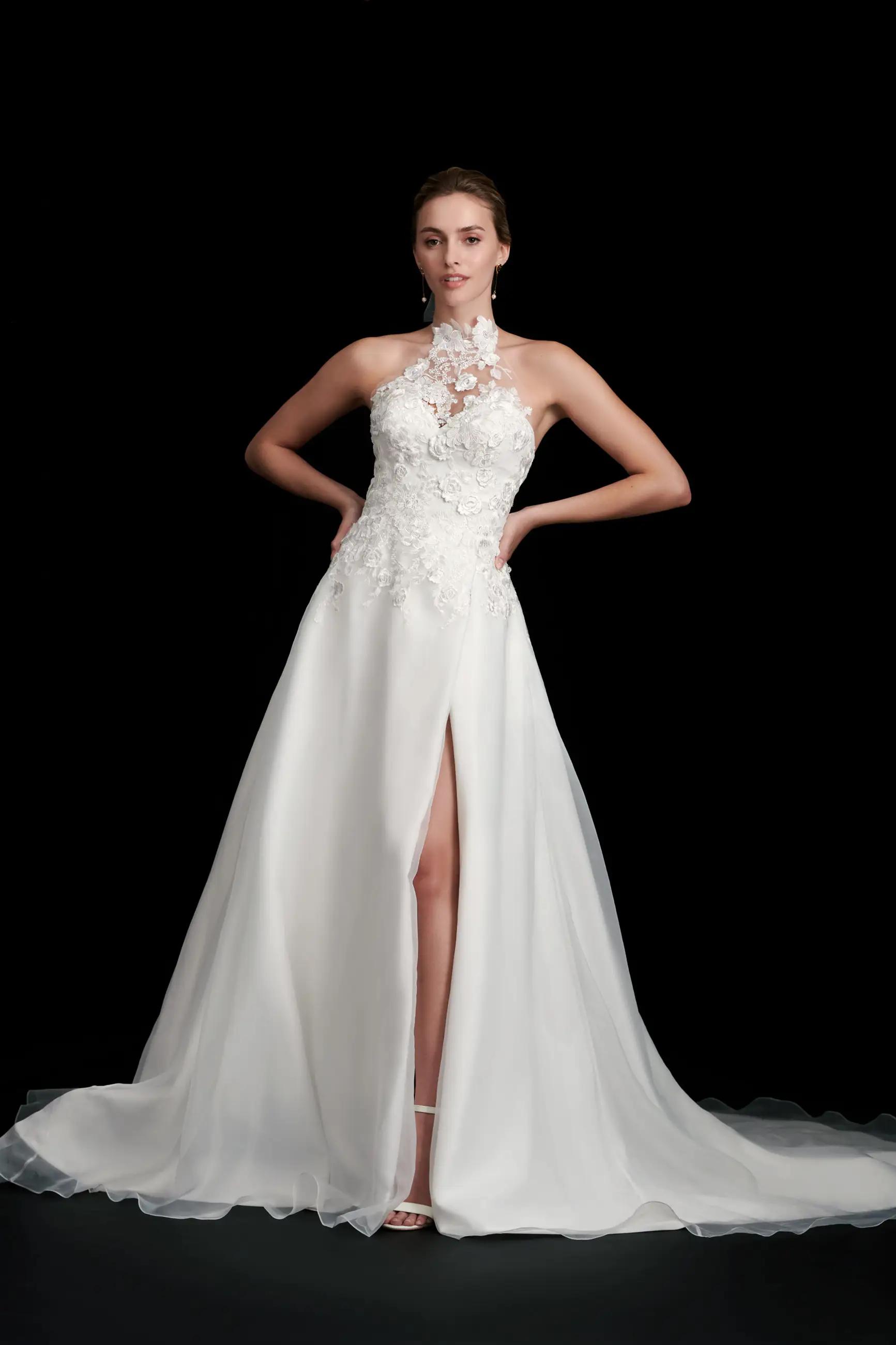 Kenna wedding dress by Kelly Faetanini with removable high mock neckline, applique bodice and a line skirt with a slit