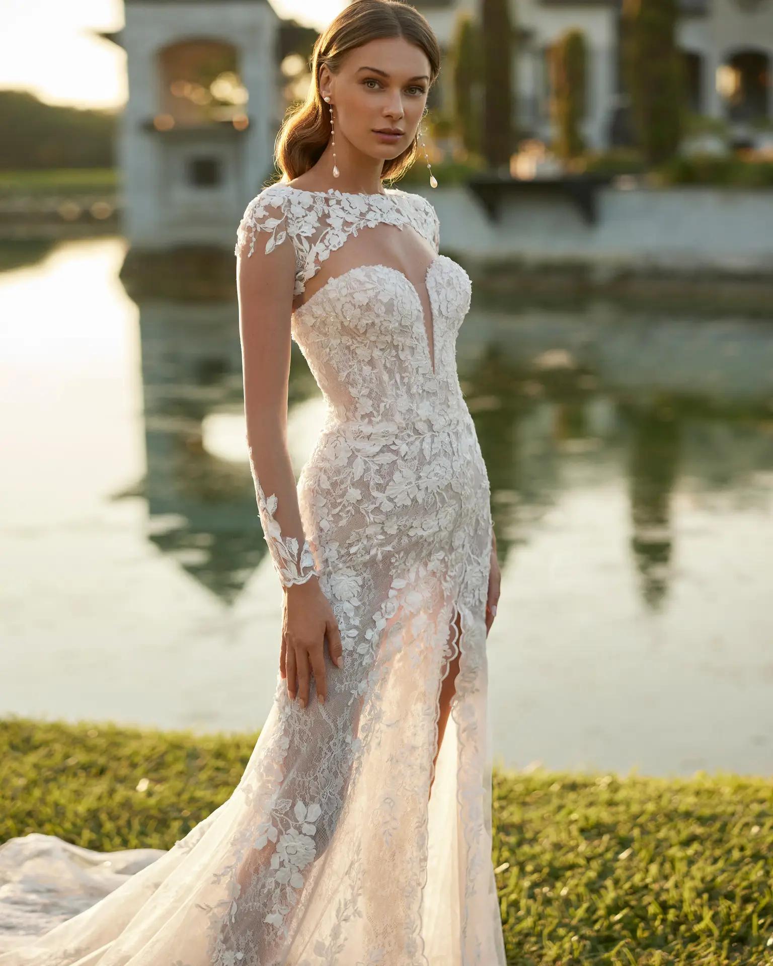Elvis wedding dress by Rosa Clara with sleeves and covered shoulders, scoop neckline and fitted lace silhouette