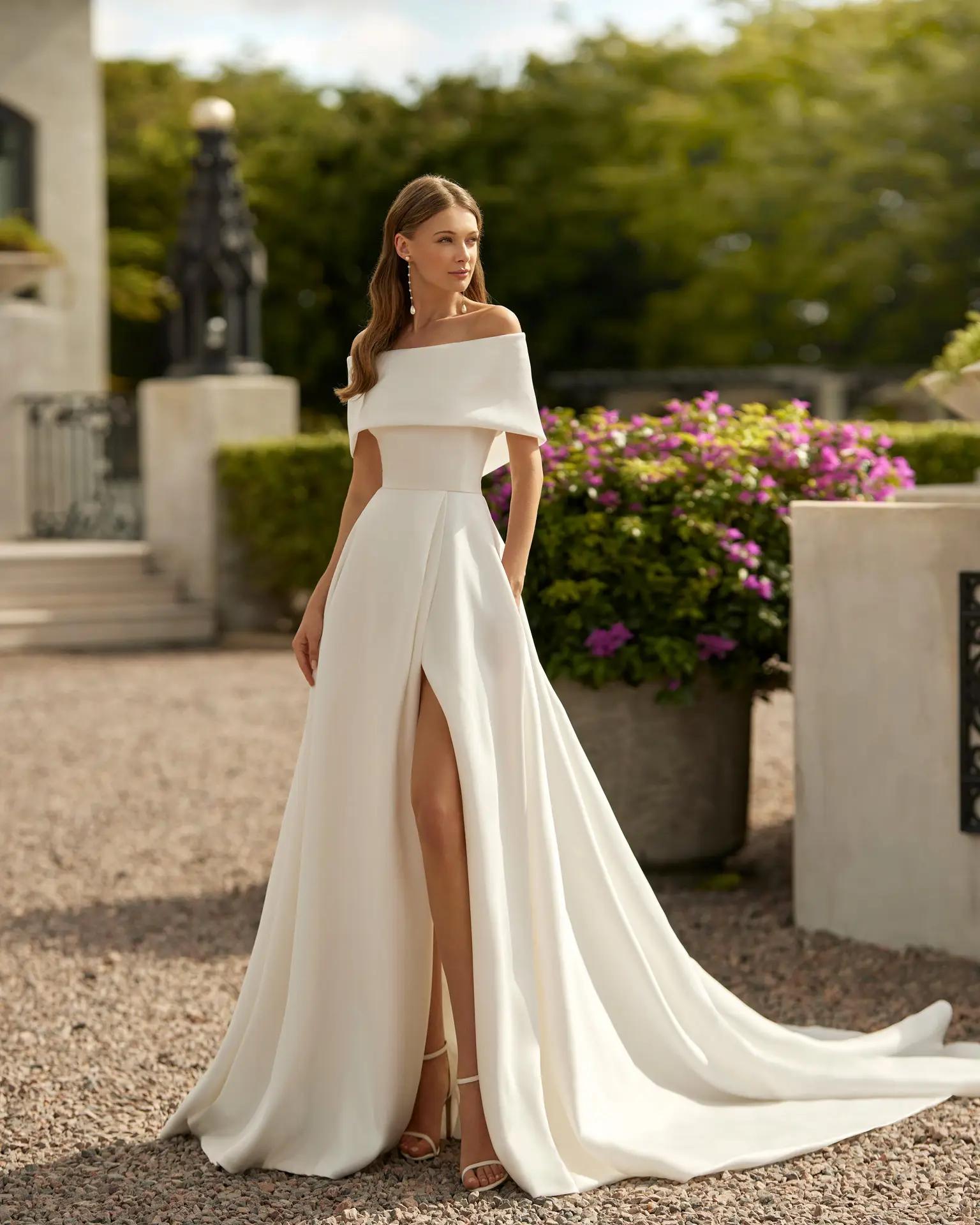 Euron ballgown wedding dress by Rosa Clara with slit and removable topper for dual bridal looks