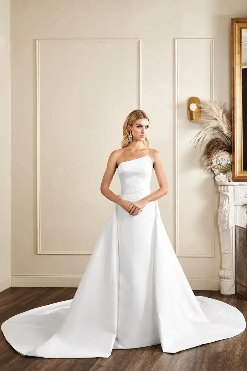 Bryant wedding dress with asymmetrical unique neckline and draped bodice fitted mikado skirt and detachable train