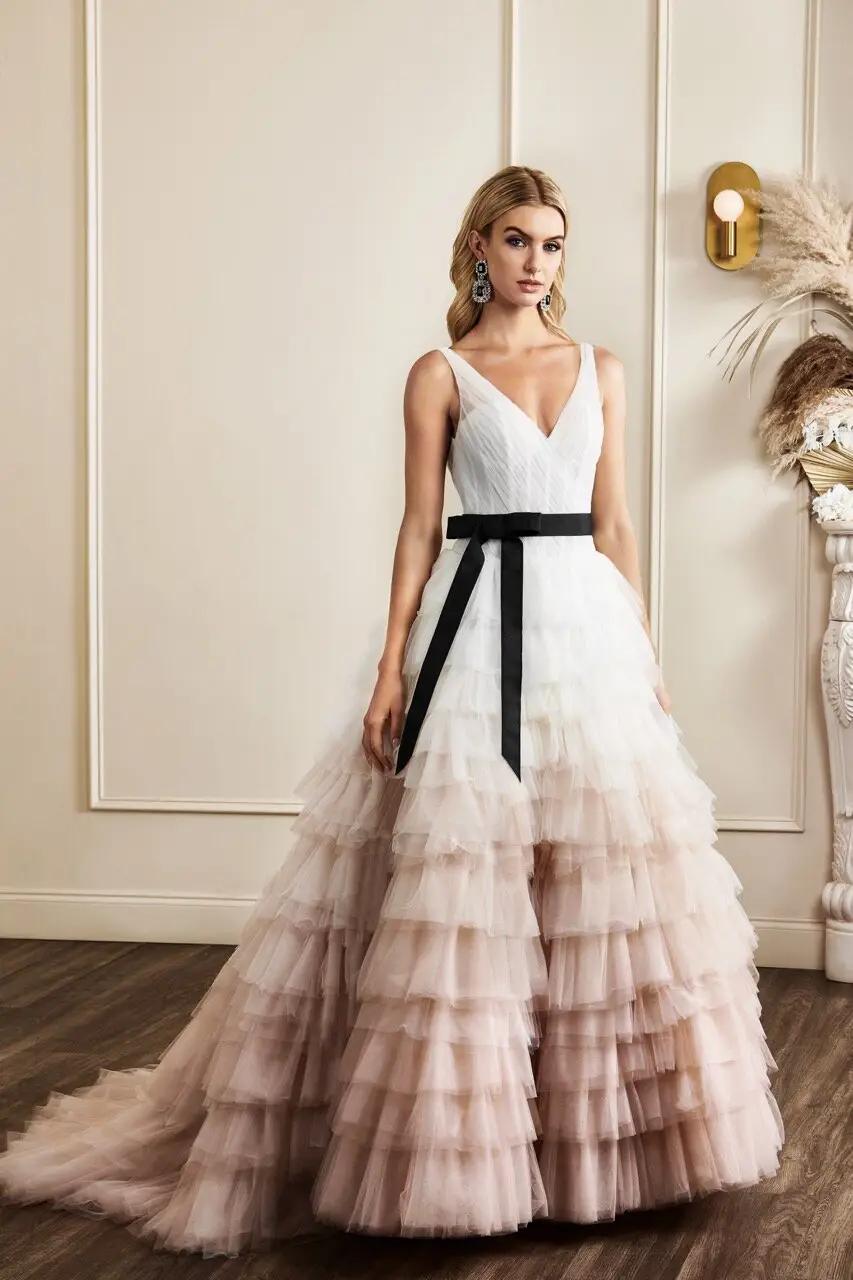 Carrie wedding dress in Columbus, Ohio by Kelly Faetanini featuring large blush ombre tulle layered skirt and v neckline with corset bodice and black belt