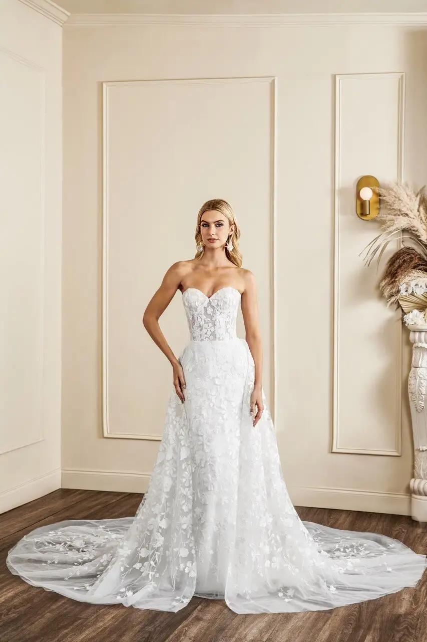 Cornelia wedding dress with floral embroidered detail corset bodice and fitted skirt, long large overskirt that is detachable by Kelly Faetanini