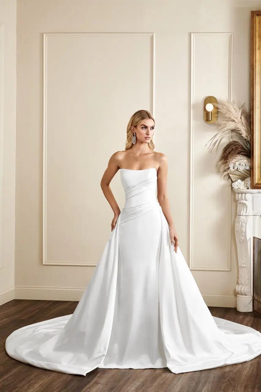 Lexington wedding dress in Columbus, Ohio with draped satin bodice and soft scoop neckline, exposed corset back and fitted silhouette, long detachable overskirt