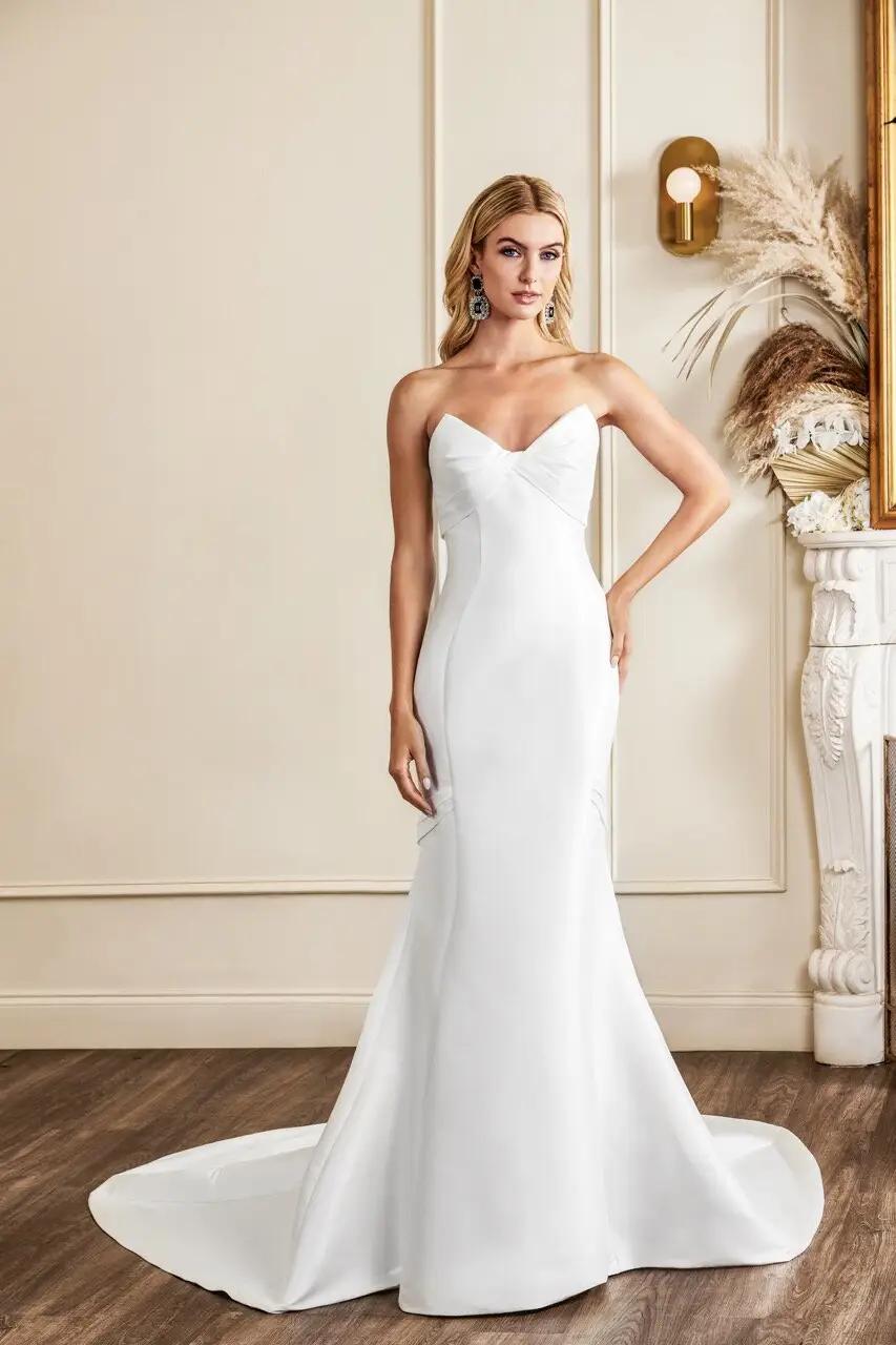 Nolita wedding dress with cat eye bodice and twist detail, no waistline and fitted mikado silhouette