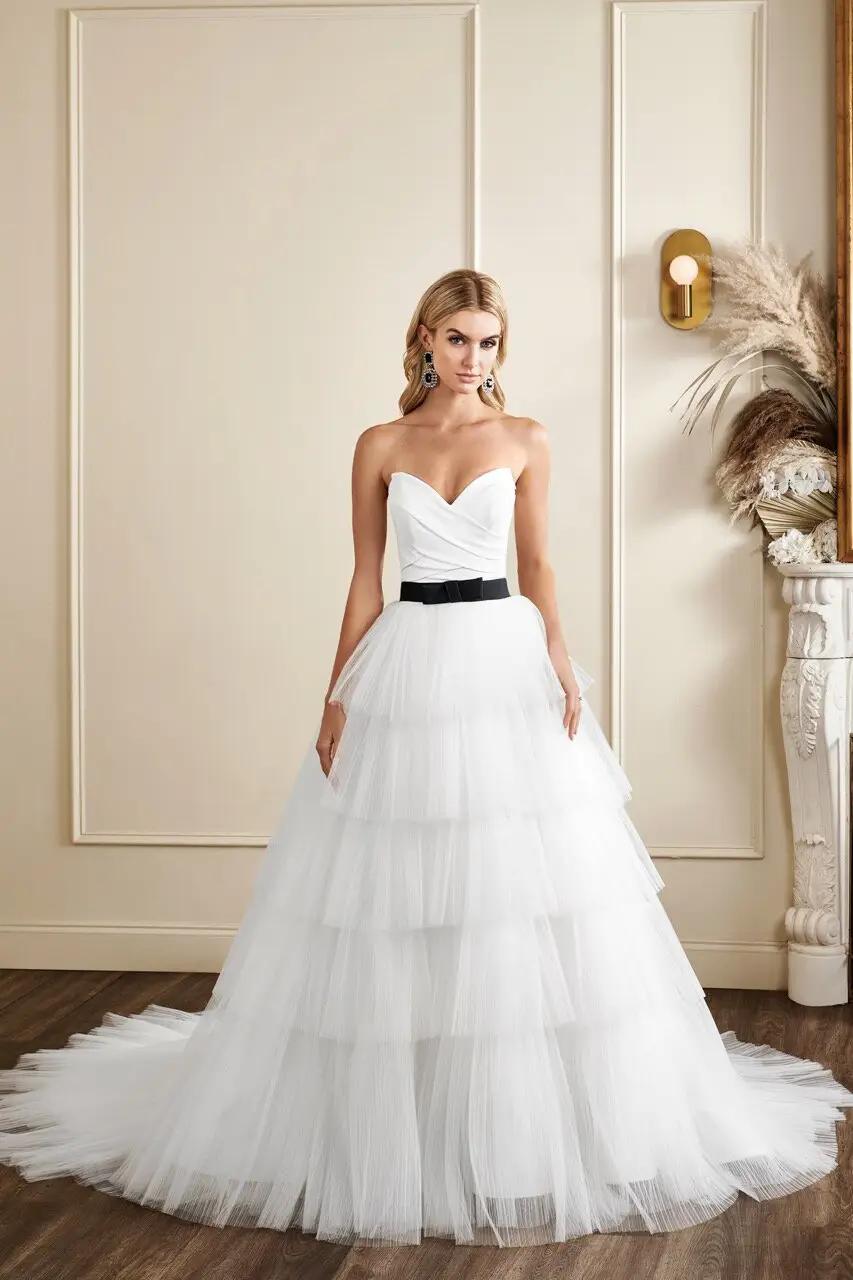 Park wedding dress in Columbus, Ohio by Kelly Faetanini with tiered over the top tulle ballgown skirt and pointed sweetheart neckline black belt