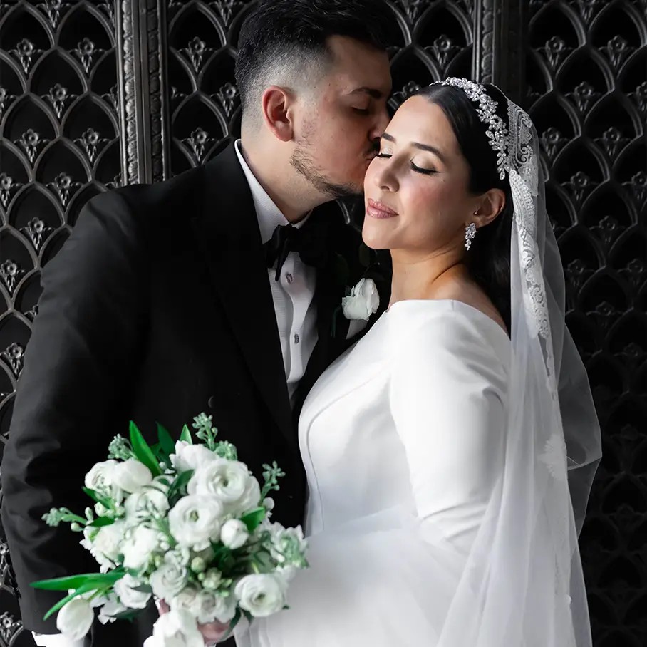 Сouple wearing a white gown and a white suit