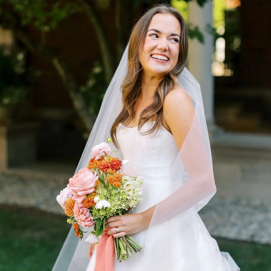 Сouple wearing a white gown and a white suit